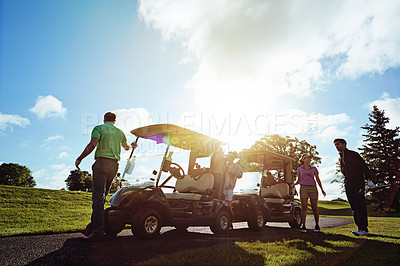 Buy stock photo Shot of friends playing a round of golf on a fairway