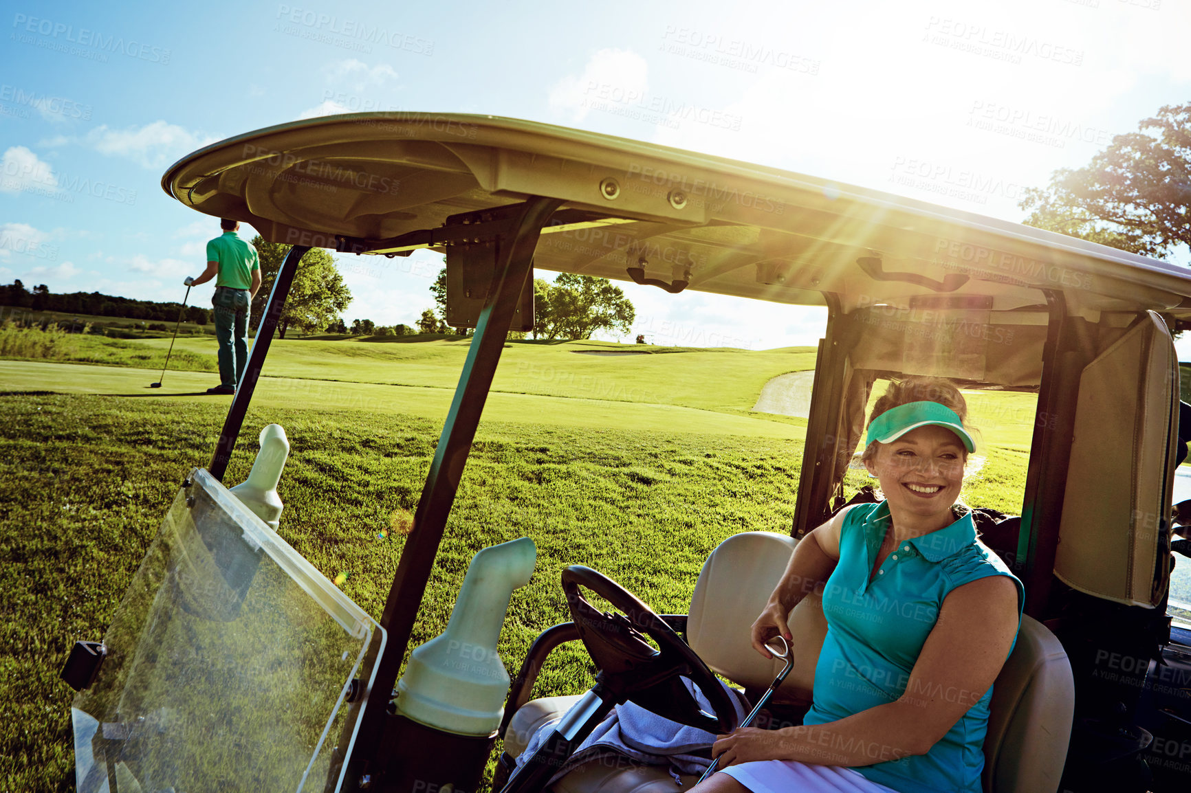 Buy stock photo Shot of woman sitting in a golf cart on the fairway