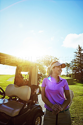 Buy stock photo Shot of woman standing next to a golf cart on the fairway