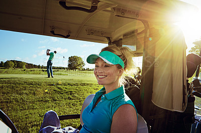 Buy stock photo Shot of woman sitting in a golf cart on the fairway