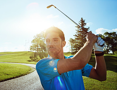 Buy stock photo Shot of a man practicing his swing on the golf course