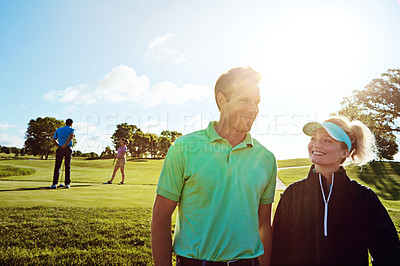 Buy stock photo Shot of a couple playing golf together on a fairway