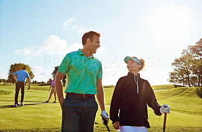 Buy stock photo Shot of a couple playing golf together on a fairway