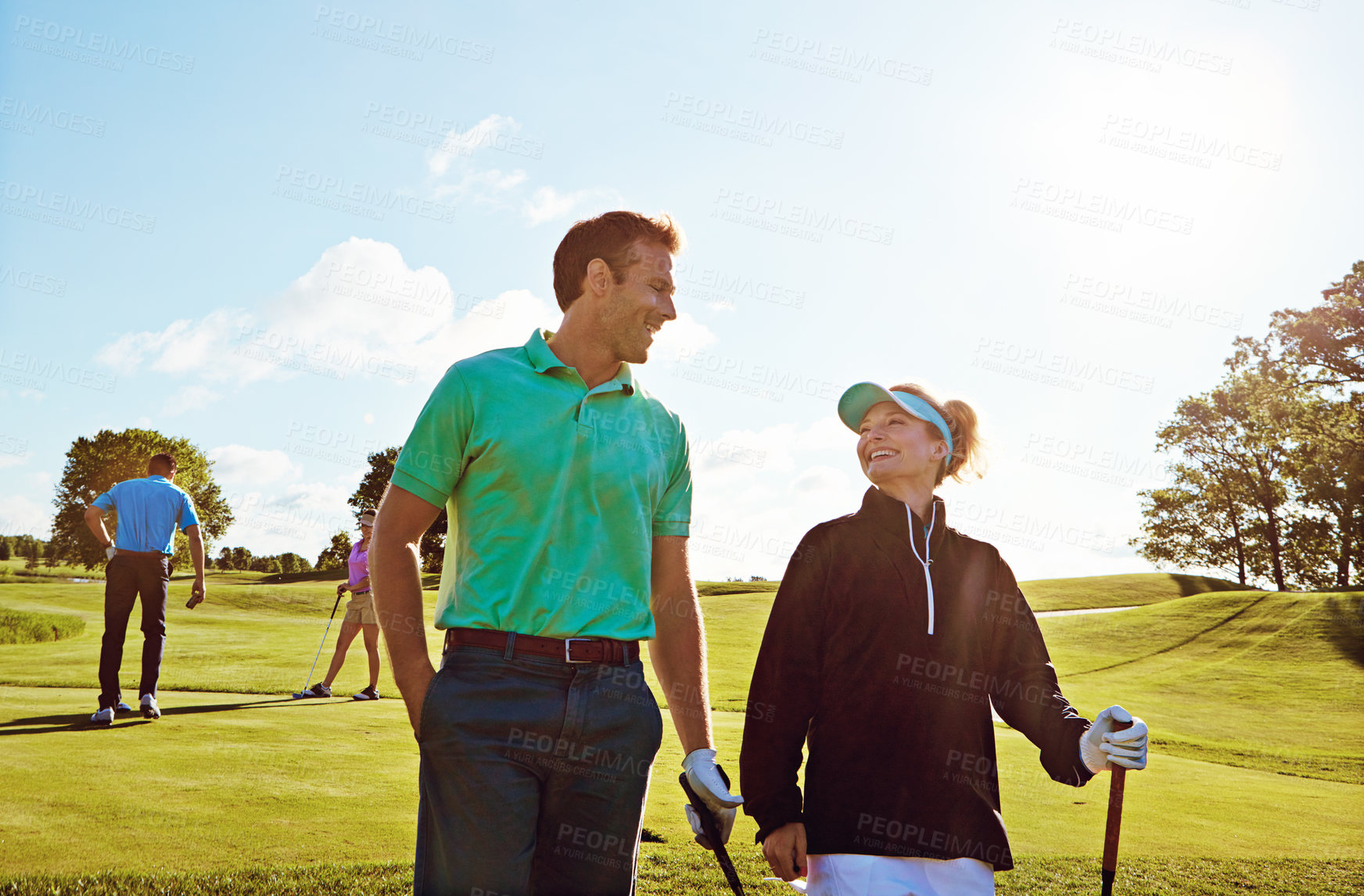 Buy stock photo Shot of a couple playing golf together on a fairway