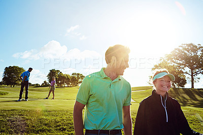 Buy stock photo Shot of a couple playing golf together on a fairway