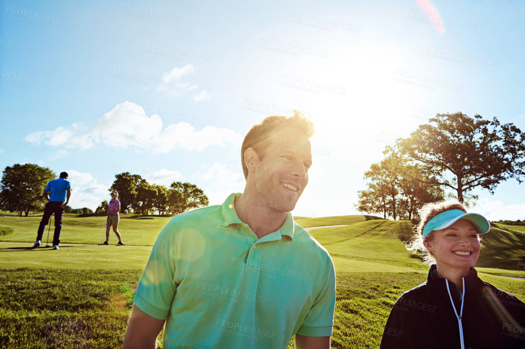 Buy stock photo Shot of a couple playing golf together on a fairway