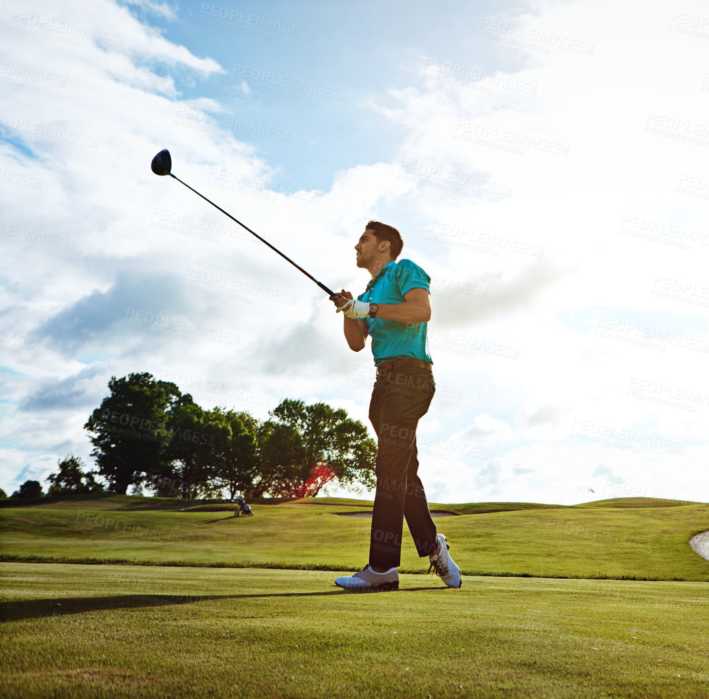 Buy stock photo Shot of a man practicing his swing on the golf course