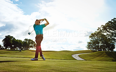 Buy stock photo Shot of a man practicing his swing on the golf course