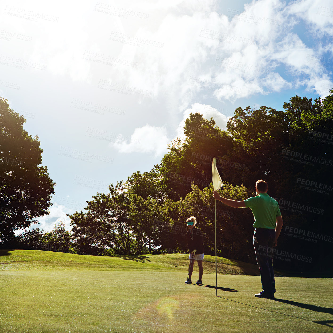 Buy stock photo Shot of a couple playing golf together on a fairway