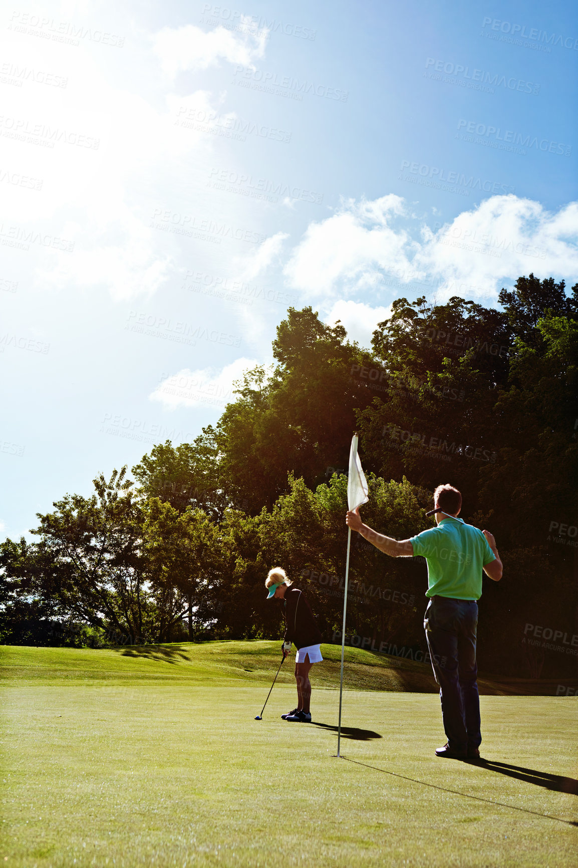 Buy stock photo Shot of a couple playing golf together on a fairway