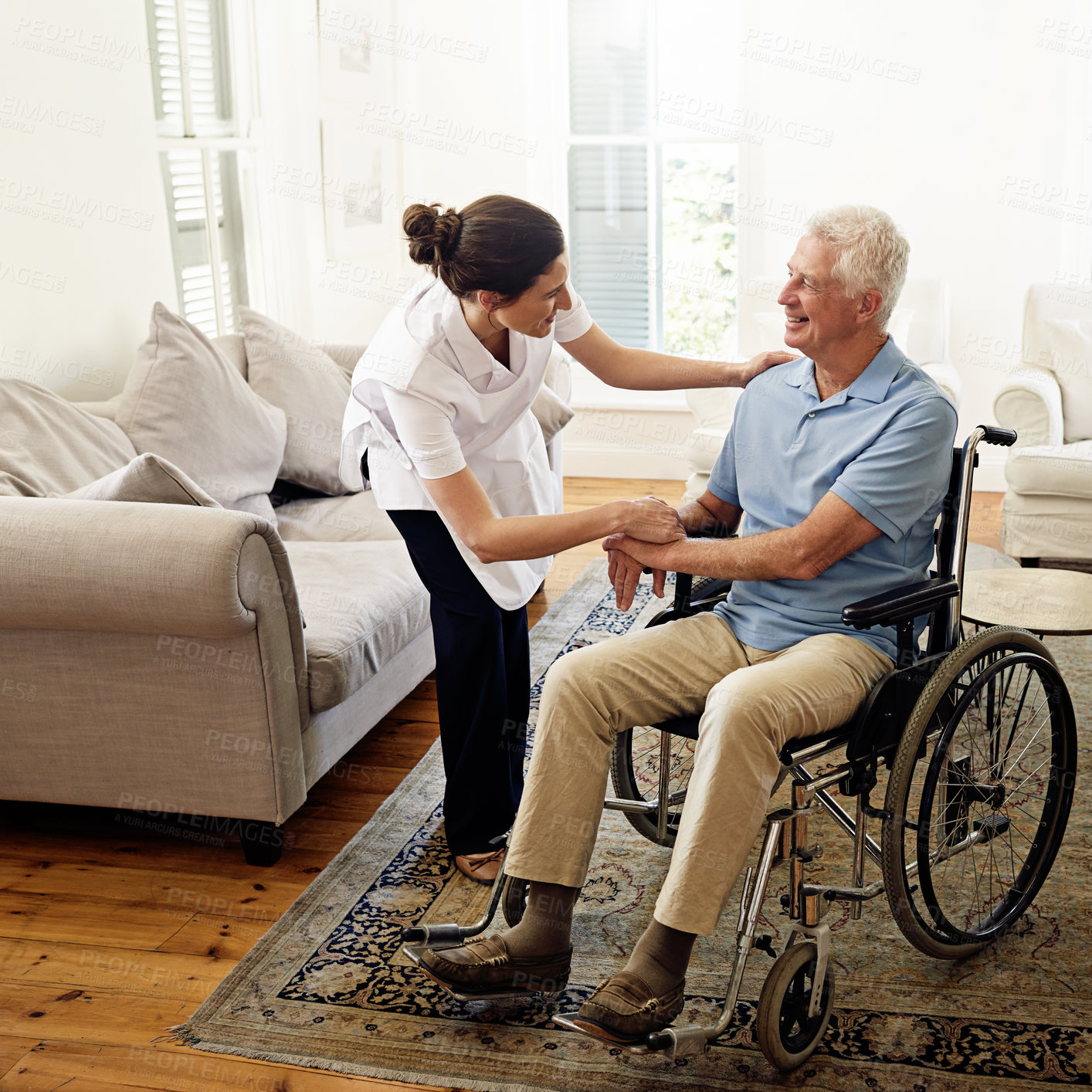 Buy stock photo Shot of a caregiver helping a senior man in a wheelchair at home