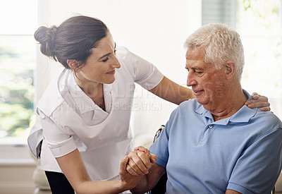 Buy stock photo Shot of a caregiver helping a senior man in a wheelchair at home