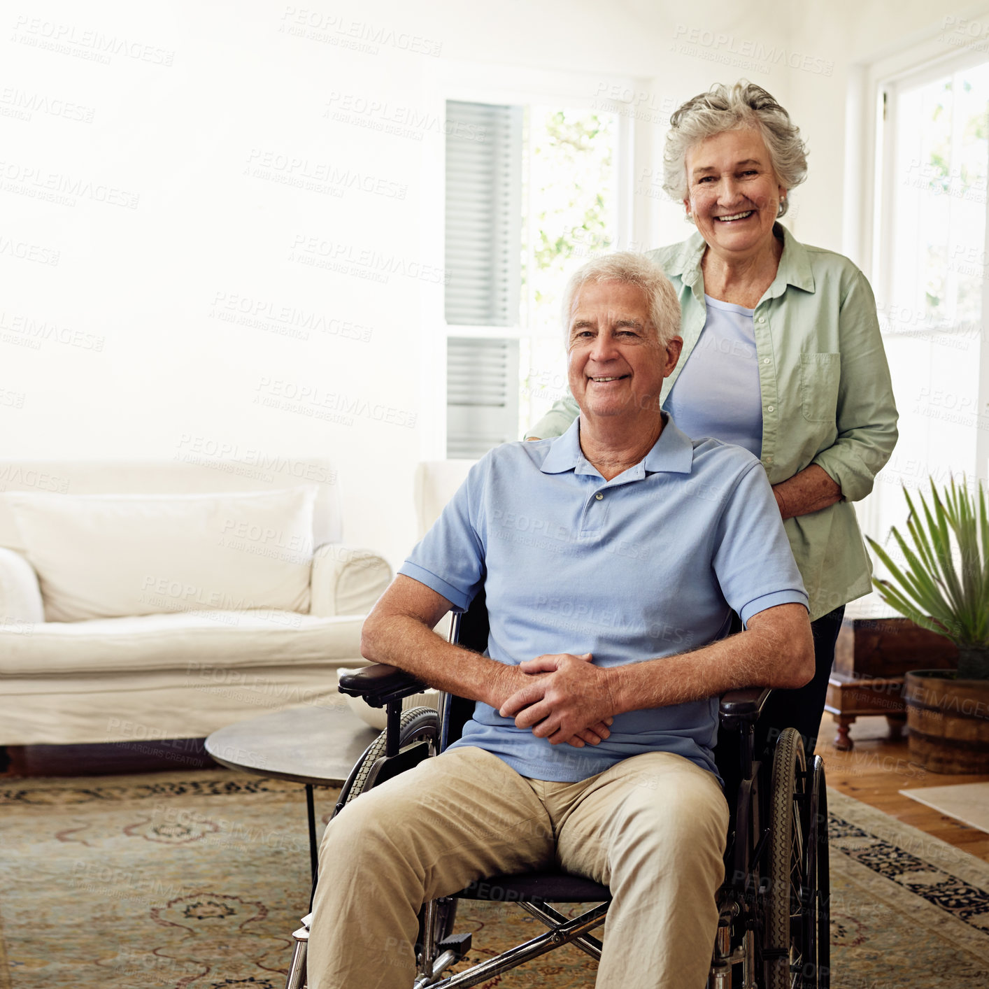 Buy stock photo Wheelchair, smile and portrait of senior couple at home for marriage, disability care and helping on weekend. Retirement, health and happy elderly woman and man in house for relax, support and love