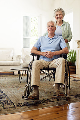 Buy stock photo Wheelchair, disability and portrait of happy old couple at home for marriage, quality time and bonding. Retirement, trust and elderly woman and man smile in living room for relax, support and love