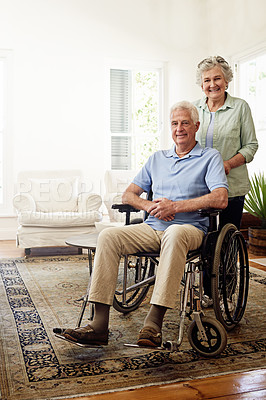 Buy stock photo Disability, smile and portrait of senior couple at home for marriage, quality time and bond together. Retirement, wheelchair and happy elderly woman and man in living room to relax, support and love