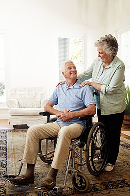Buy stock photo Disability, wheelchair and happy senior couple enjoy affection and bonding together. Retirement home, marriage and elderly woman and man smile in living room for relax, support and love with mockup