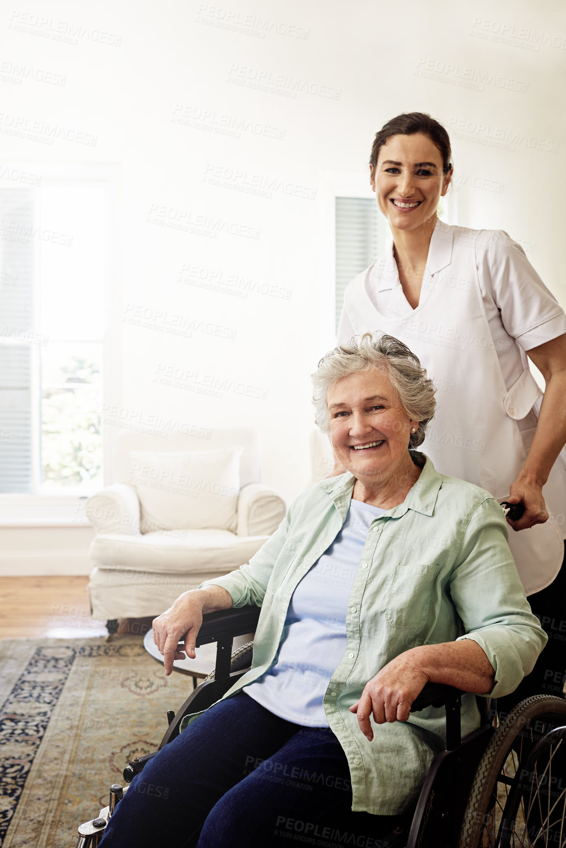 Buy stock photo Portrait of a smiling caregiver and a senior woman in a wheelchair at home