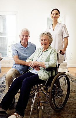 Buy stock photo Portrait, smile and wheelchair, senior couple with caregiver at nursing home for disability and rehabilitation. Healthcare, elderly care and retirement, old woman and man with nurse in living room.