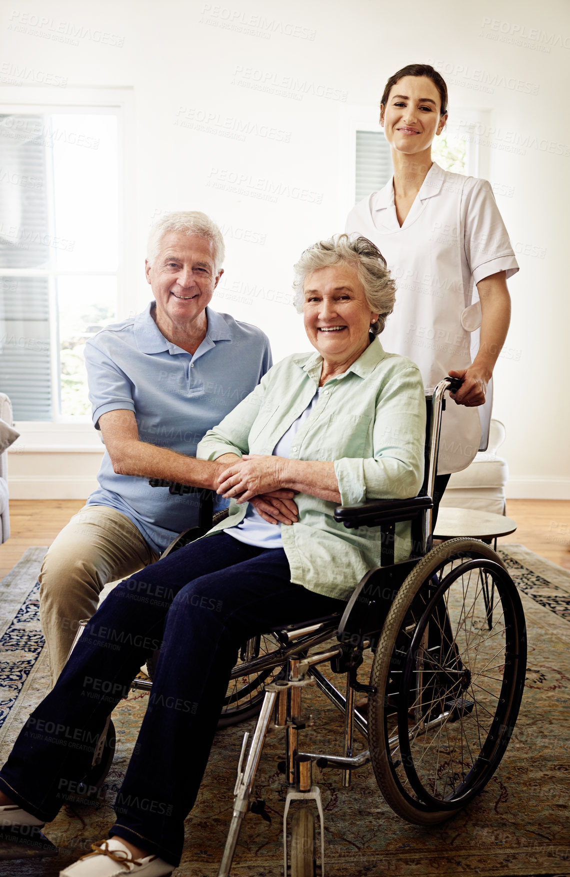 Buy stock photo Portrait, smile and wheelchair, senior couple with caregiver at nursing home for disability and rehabilitation. Healthcare, elderly care and retirement, old woman and man with nurse in living room.