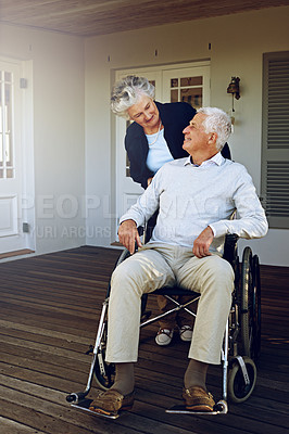 Buy stock photo Wheelchair, retirement and happy senior couple enjoy bonding, quality time and marriage on outdoor patio. Disability, love and elderly man and woman smile for support, wellness and relax at home