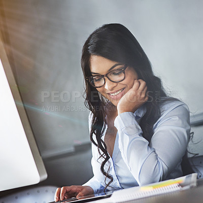 Buy stock photo Shot of a young businesswoman sitting at a desk using a digital tablet