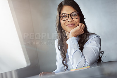 Buy stock photo Portrait of a young businesswoman sitting at her desk in the office