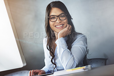 Buy stock photo Portrait of a young businesswoman sitting at her desk in the office