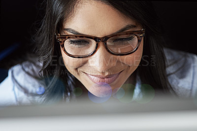 Buy stock photo Shot of a young businesswoman sitting at a desk using a digital tablet