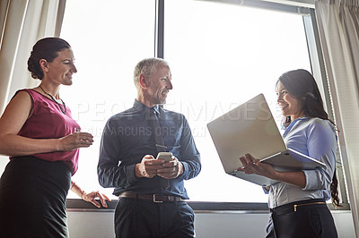 Buy stock photo Cropped shot of three businesspeople meeting in the office