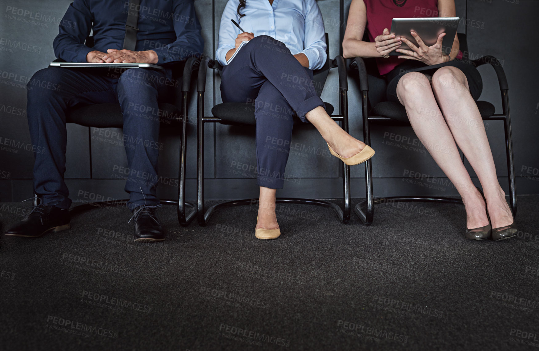 Buy stock photo Cropped shot of three unrecognizable people sitting in line for an interview