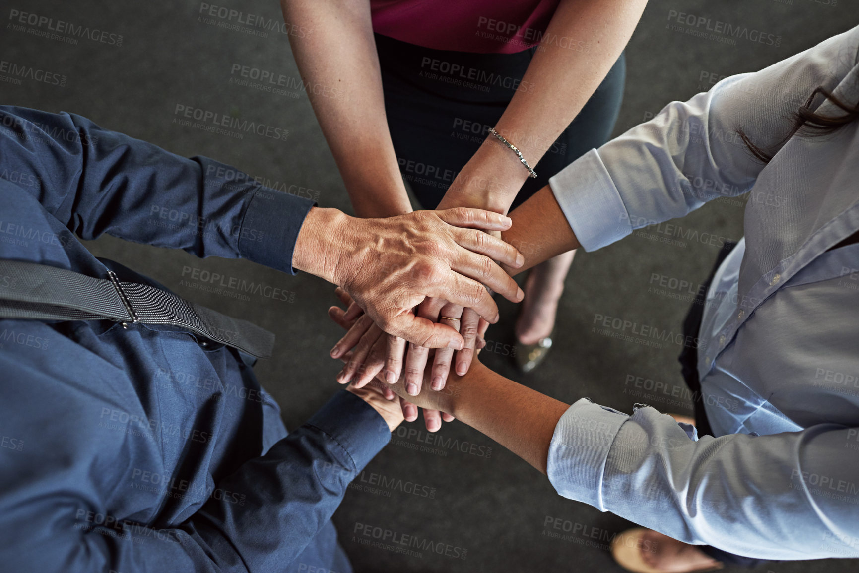 Buy stock photo High angle shot of a group of businesspeople's hands in a huddle