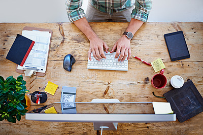 Buy stock photo High angle shot of a designer sitting at a desk working on a computer