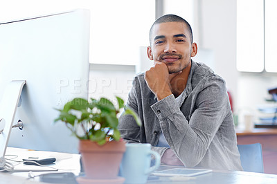 Buy stock photo Portrait of a smiling young designer working on a computer at a desk in an office