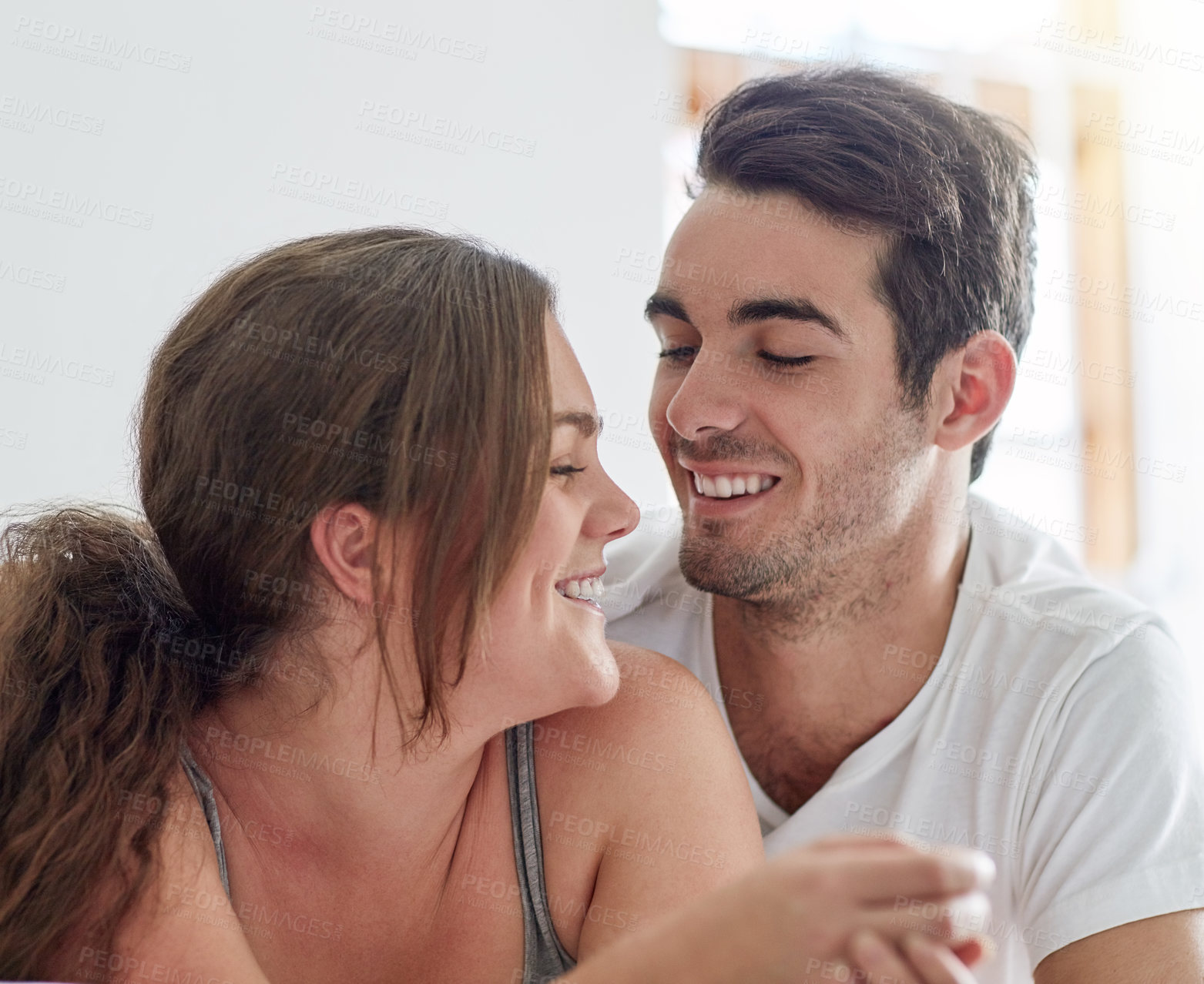 Buy stock photo Laugh, love and couple talking in home for care, support and bonding together in house Romance, happy man and woman with connection for healthy relationship, marriage or commitment for partnership