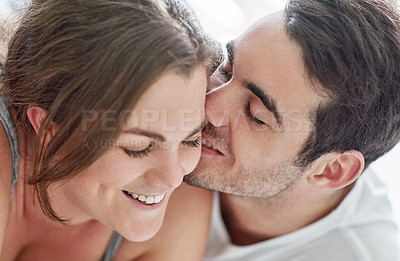 Buy stock photo Kiss, love and face of happy couple in home for care, support or bonding together in apartment. Romance, man and woman with connection for healthy relationship, marriage or commitment for partnership