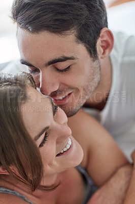 Buy stock photo Shot of a young couple sharing an affectionate moment at home