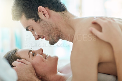 Buy stock photo Love, happy and couple in bed with romance, intimacy and desire, connection and bonding in their home together. Foreplay, eye contact and people in a bedroom with passion for honeymoon or anniversary
