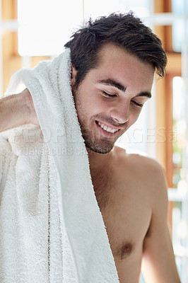 Buy stock photo Shot of a handsome young man drying himself off with a towel