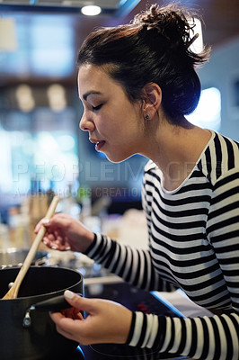 Buy stock photo Woman, kitchen and cooking for dinner and spoon, stir and food in home. Concentration, recipe and chef for supper in house and diet, ingredients and healthy meal culinary preparation on stove top 