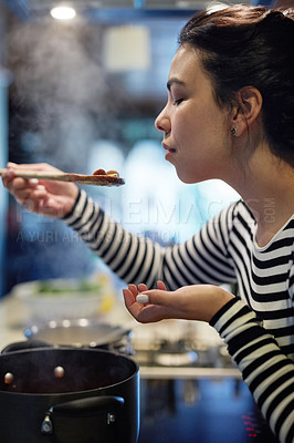 Buy stock photo Woman, cooking and food with taste in kitchen for flavor, test and evaluation of ingredients. Home, nutrition and female person with spoon in hand for dinner, preparation and assessment of recipe