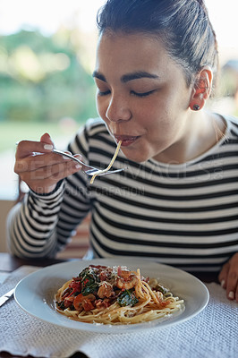 Buy stock photo Portrait of an attractive young woman eating pasta