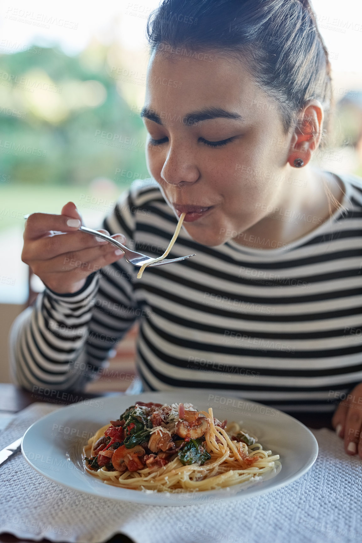 Buy stock photo Portrait of an attractive young woman eating pasta