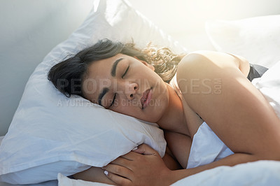 Buy stock photo Shot of an attractive young woman sleeping in bed