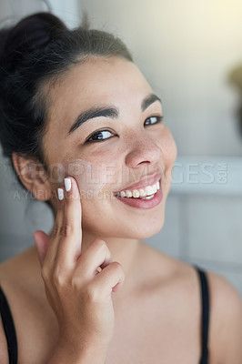 Buy stock photo Woman, portrait and apply lotion in bathroom, skincare and moisturizer for hydration in home. Female person, spa treatment and morning routine for cosmetics, dermatology and smile for facial cream