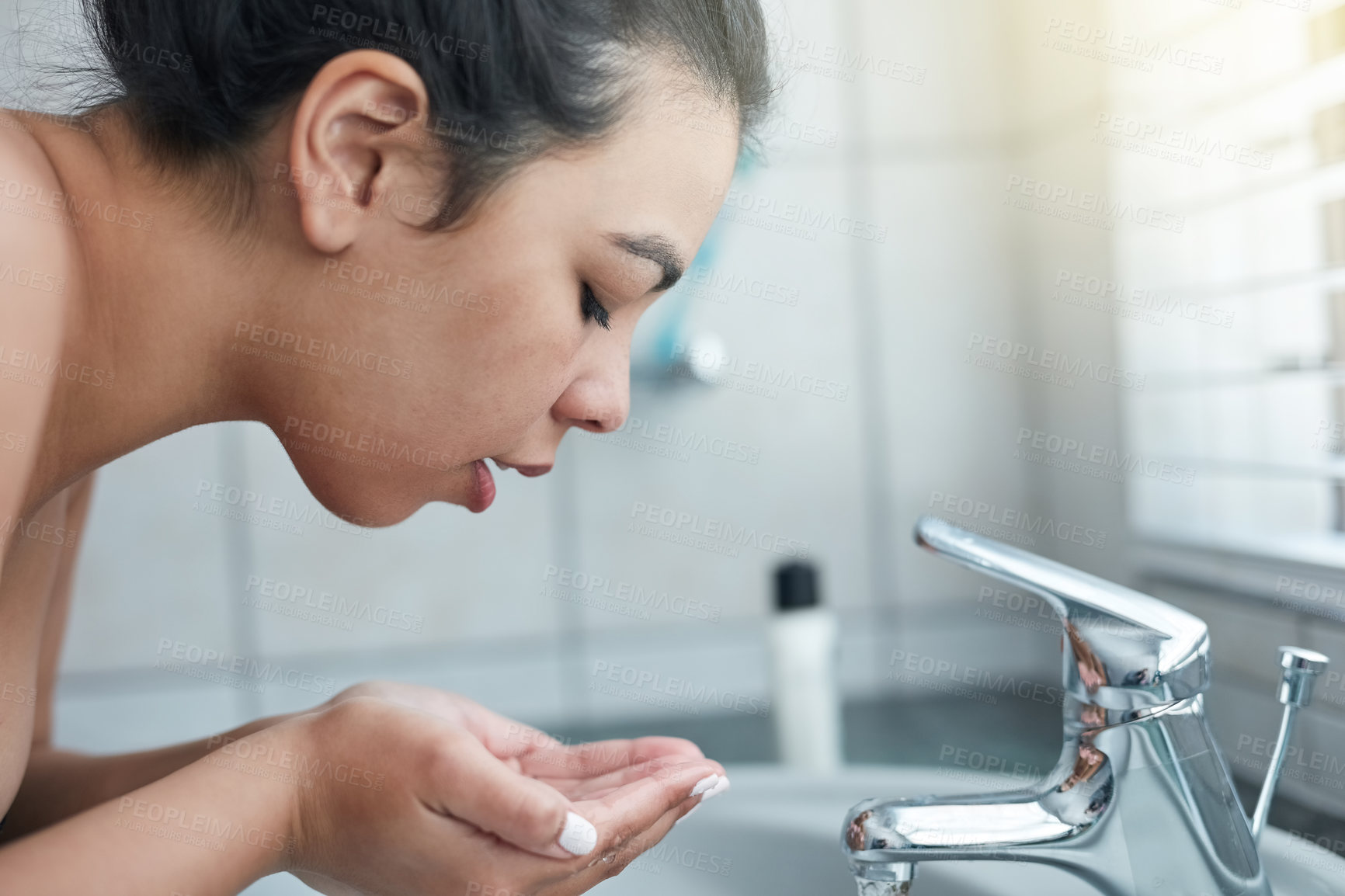 Buy stock photo Hands, washing face and woman in bathroom for facial cleanse, healthcare and morning routine. Asian person, hygiene and sink with cleaning for skincare, natural self care and wellness at home