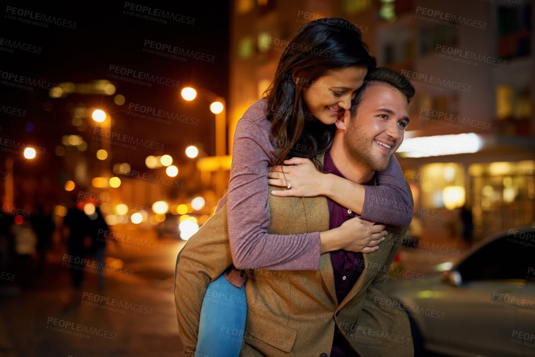 Buy stock photo Cropped shot of an affectionate young couple enjoying a night out