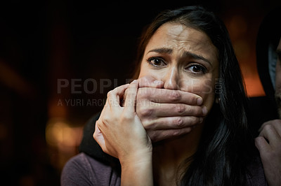 Buy stock photo Portrait of a frightened young woman with her assailant's hand over her mouth