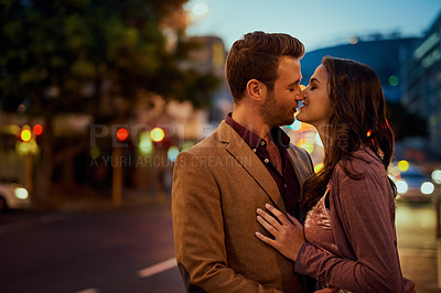 Buy stock photo Couple, night and city street with hug and kiss on date, romance and bonding with love in relationship. Affection, people with commitment and trust, sweet moment and romantic together outdoor