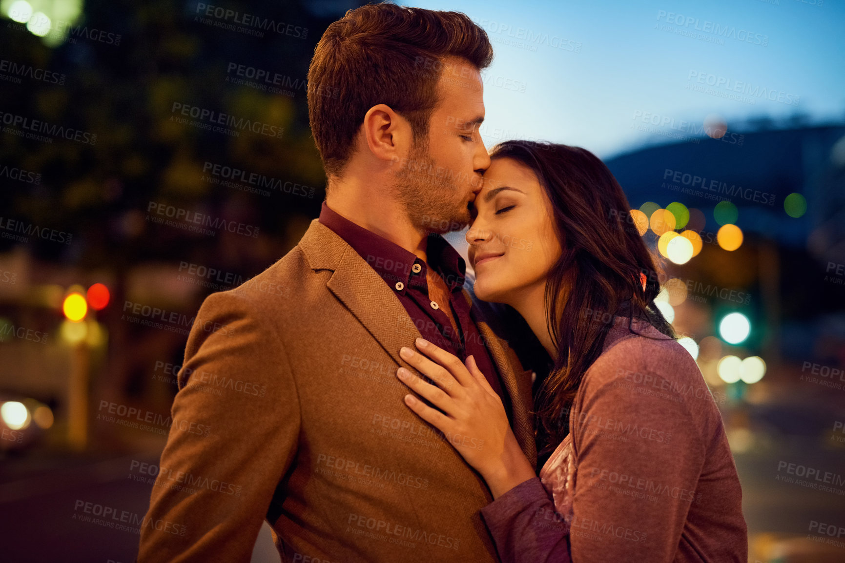 Buy stock photo Cropped shot of an affectionate young couple enjoying a night out