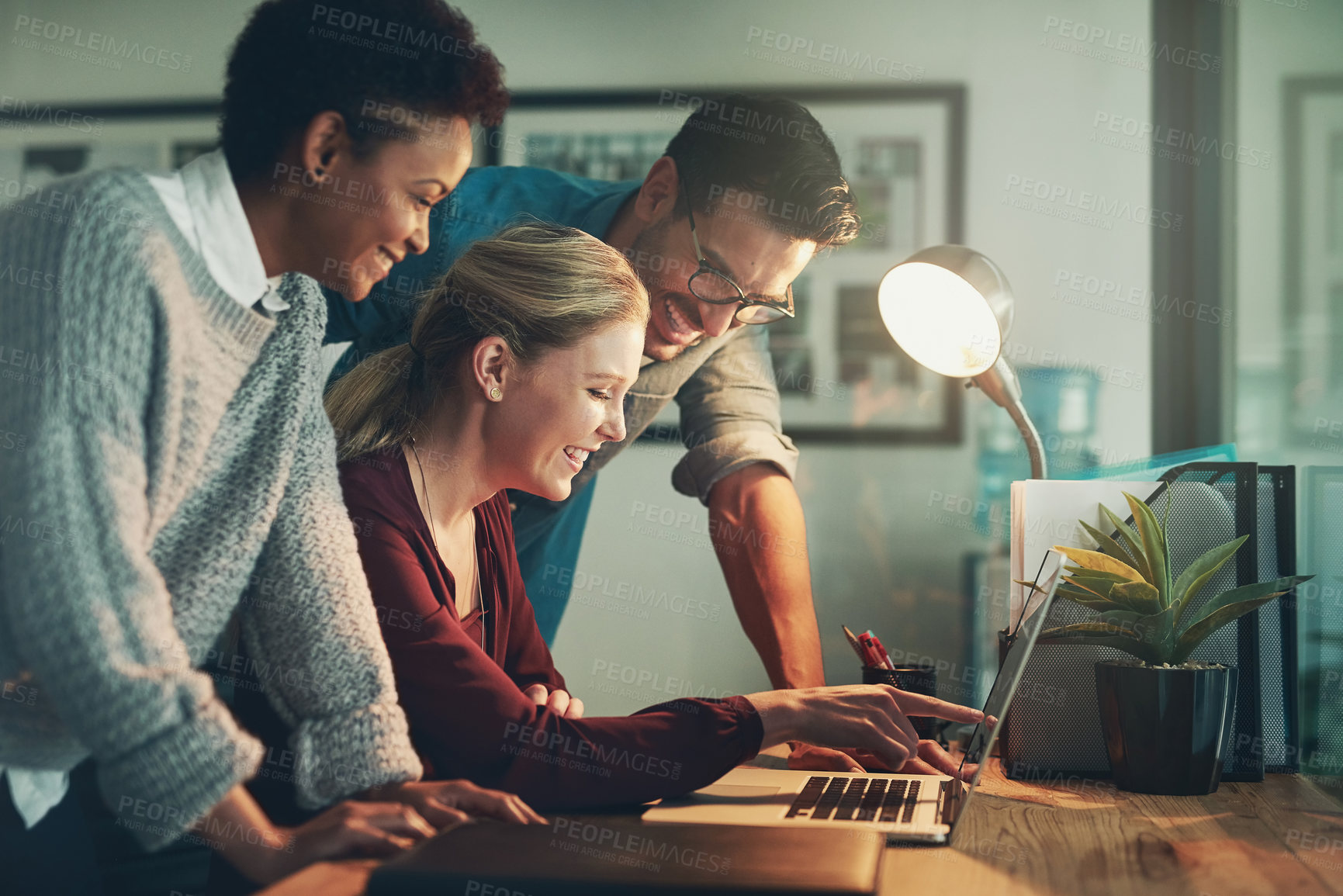 Buy stock photo Business people, laptop and night with meeting in teamwork for planning, design or deadline at office desk. Group of employees working late with smile on computer for creative startup at workplace